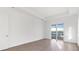 Bedroom with tile floors, and sliding glass doors overlooking a beautiful lake at 8604 Shore Lake Dr, Englewood, FL 34224