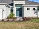 Charming home featuring a double front door, manicured lawn, and brick pathway at 8604 Shore Lake Dr, Englewood, FL 34224