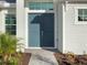 Inviting entryway showcasing a double front door, landscaping, and a brick walkway at 8604 Shore Lake Dr, Englewood, FL 34224