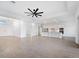 Open-concept living area with tile floors flows into modern kitchen, perfect for entertaining at 8604 Shore Lake Dr, Englewood, FL 34224