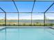 Screened pool boasts beautiful lake views, providing a serene backyard oasis at 8604 Shore Lake Dr, Englewood, FL 34224