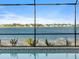 Screened-in pool with serene lake views, perfect for relaxation and enjoying the scenery at 8604 Shore Lake Dr, Englewood, FL 34224