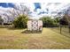 View of storage shed in backyard, surrounded by chain-link fence at 917 Tropical Nw Ave, Port Charlotte, FL 33948