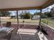 Screened-in porch looking out to a large fenced yard with mature landscaping and a shed at 917 Tropical Nw Ave, Port Charlotte, FL 33948