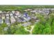 An aerial view of a serene neighborhood with neat rows of houses nestled amidst trees and green spaces at 12492 Shimmering Oak Cir, Venice, FL 34293