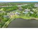 An aerial view of a community park and pool surrounded by palm trees and green landscaping at 12492 Shimmering Oak Cir, Venice, FL 34293