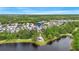 A beautiful aerial view of the residential community showcasing a lake and lush landscaping at 12492 Shimmering Oak Cir, Venice, FL 34293