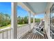 Outdoor balcony with views of the neighborhood, and white rocking chairs to relax in at 12492 Shimmering Oak Cir, Venice, FL 34293