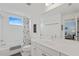 Bright bathroom featuring a shower-tub combo, patterned shower curtain and a spacious vanity at 12492 Shimmering Oak Cir, Venice, FL 34293