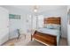Well-lit bedroom features coastal decor, comfortable chair, and a light blue color scheme at 12492 Shimmering Oak Cir, Venice, FL 34293