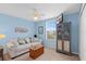 Bright bedroom with ceiling fan, view of neighborhood, and a comfy sofa at 12492 Shimmering Oak Cir, Venice, FL 34293