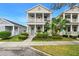 Charming two-story home featuring a welcoming front porch and beautifully landscaped yard at 12492 Shimmering Oak Cir, Venice, FL 34293