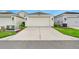 Attached single-car garage featuring a concrete driveway and carriage style garage door at 12492 Shimmering Oak Cir, Venice, FL 34293