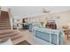 Spacious living room with a staircase, open to the kitchen and dining area at 12492 Shimmering Oak Cir, Venice, FL 34293