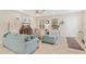 Bright living room featuring tile floors, comfortable seating, and plenty of natural light at 12492 Shimmering Oak Cir, Venice, FL 34293