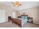 Comfortable bedroom with ceiling fan, three windows, and ample natural light at 12492 Shimmering Oak Cir, Venice, FL 34293
