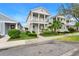 Charming two-story home with a quaint front porch and beautiful landscaped yard viewed from the street at 12492 Shimmering Oak Cir, Venice, FL 34293
