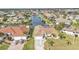 Beautiful canal-front home showcasing lush landscaping, a tile roof, and easy water access at 1303 Casey Key Dr, Punta Gorda, FL 33950