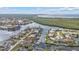 An aerial photograph features residential homes along a tranquil body of water at 1303 Casey Key Dr, Punta Gorda, FL 33950