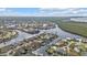 Aerial view showcasing a coastal neighborhood featuring waterfront homes along canals with boat docks and water access at 1303 Casey Key Dr, Punta Gorda, FL 33950