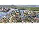 Aerial photograph features tile-roofed homes along calm waterways at 1303 Casey Key Dr, Punta Gorda, FL 33950