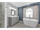 Stylish bathroom with soaking tub, granite countertops, and patterned tile floor at 1303 Casey Key Dr, Punta Gorda, FL 33950