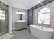 Elegant bathroom with soaking tub, walk-in shower, granite countertops, and decorative tile floor at 1303 Casey Key Dr, Punta Gorda, FL 33950