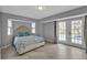 Bedroom with wood floors and patio doors leading to the pool at 1303 Casey Key Dr, Punta Gorda, FL 33950