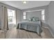 Comfortable bedroom with wood floors and view of the front yard at 1303 Casey Key Dr, Punta Gorda, FL 33950