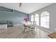 Dining room with a large table, bright windows, and hardwood flooring at 1303 Casey Key Dr, Punta Gorda, FL 33950