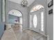Light-filled entry area showcasing hardwood floors and seamless archways into dining area at 1303 Casey Key Dr, Punta Gorda, FL 33950