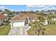 Lovely home boasting a well-maintained lawn, mature palm trees, and a charming tile roof at 1303 Casey Key Dr, Punta Gorda, FL 33950
