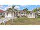 Attractive home with a tile roof, lush green lawn, and mature palm trees offering great curb appeal at 1303 Casey Key Dr, Punta Gorda, FL 33950