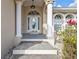 Elegant front entrance featuring white columns, arched windows, and a decorative glass front door at 1303 Casey Key Dr, Punta Gorda, FL 33950