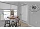 Kitchen nook with cafe table, lots of light from the windows, and a decorative clock on the wall at 1303 Casey Key Dr, Punta Gorda, FL 33950