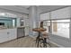 Eat-in-kitchen with stainless appliances, white cabinets, breakfast table next to a sunny window, and tile floors at 1303 Casey Key Dr, Punta Gorda, FL 33950