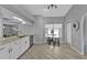 Eat in kitchen with white cabinets, tile floors, stainless steel appliances, and bar seating at 1303 Casey Key Dr, Punta Gorda, FL 33950