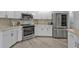 Modern kitchen featuring stainless steel appliances, white cabinets, and stylish backsplash, perfect for cooking at 1303 Casey Key Dr, Punta Gorda, FL 33950