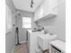 Efficient laundry room with a washer, dryer, sink, and ample cabinet storage at 1303 Casey Key Dr, Punta Gorda, FL 33950
