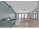 Open living and dining area features wood floors, arched windows, and modern décor at 1303 Casey Key Dr, Punta Gorda, FL 33950