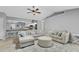 Open concept living room and kitchen, showcasing lots of seating and a light gray color palette at 1303 Casey Key Dr, Punta Gorda, FL 33950