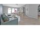 Inviting living and dining area with arched entry, wood floors, and ample natural light at 1303 Casey Key Dr, Punta Gorda, FL 33950