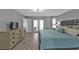 Well-lit main bedroom with wood floors, double doors, and modern furniture at 1303 Casey Key Dr, Punta Gorda, FL 33950