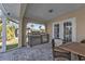 Outdoor grill setup with stainless steel appliances and stone accents on the patio for elegant outdoor cooking at 1303 Casey Key Dr, Punta Gorda, FL 33950