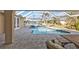 Inviting patio with comfortable seating area and a refreshing pool, complemented by waterfront views at 1303 Casey Key Dr, Punta Gorda, FL 33950