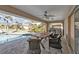 Covered patio with outdoor dining area, fan, and built-in grill, providing an ideal space for entertaining at 1303 Casey Key Dr, Punta Gorda, FL 33950