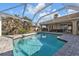 Beautiful, screened-in pool area with a water view, creating a tranquil and private backyard oasis at 1303 Casey Key Dr, Punta Gorda, FL 33950