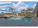 Stunning screened-in pool featuring clear blue water, overlooking a canal with boat dock, perfect for relaxation at 1303 Casey Key Dr, Punta Gorda, FL 33950