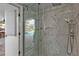 Bathroom with a glass door to the pool and an elegant marble tiled shower at 1303 Casey Key Dr, Punta Gorda, FL 33950