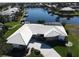 Aerial view of a stunning home with a pristine white roof and direct access to a tranquil waterfront canal at 1407 Waxwing Ct, Punta Gorda, FL 33950